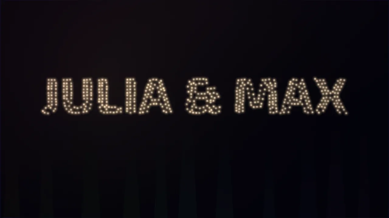 The grand entrance on the room screen: the names JULIA & MAX spelled out by light drones in a darkened room